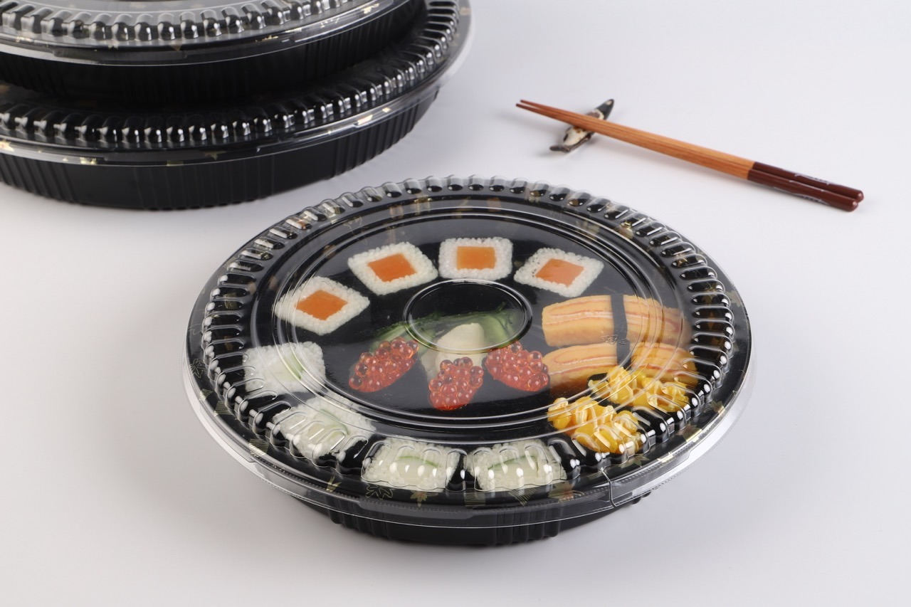 WL53 black sushi tray with clear plastic lid displaying assorted sushi rolls
