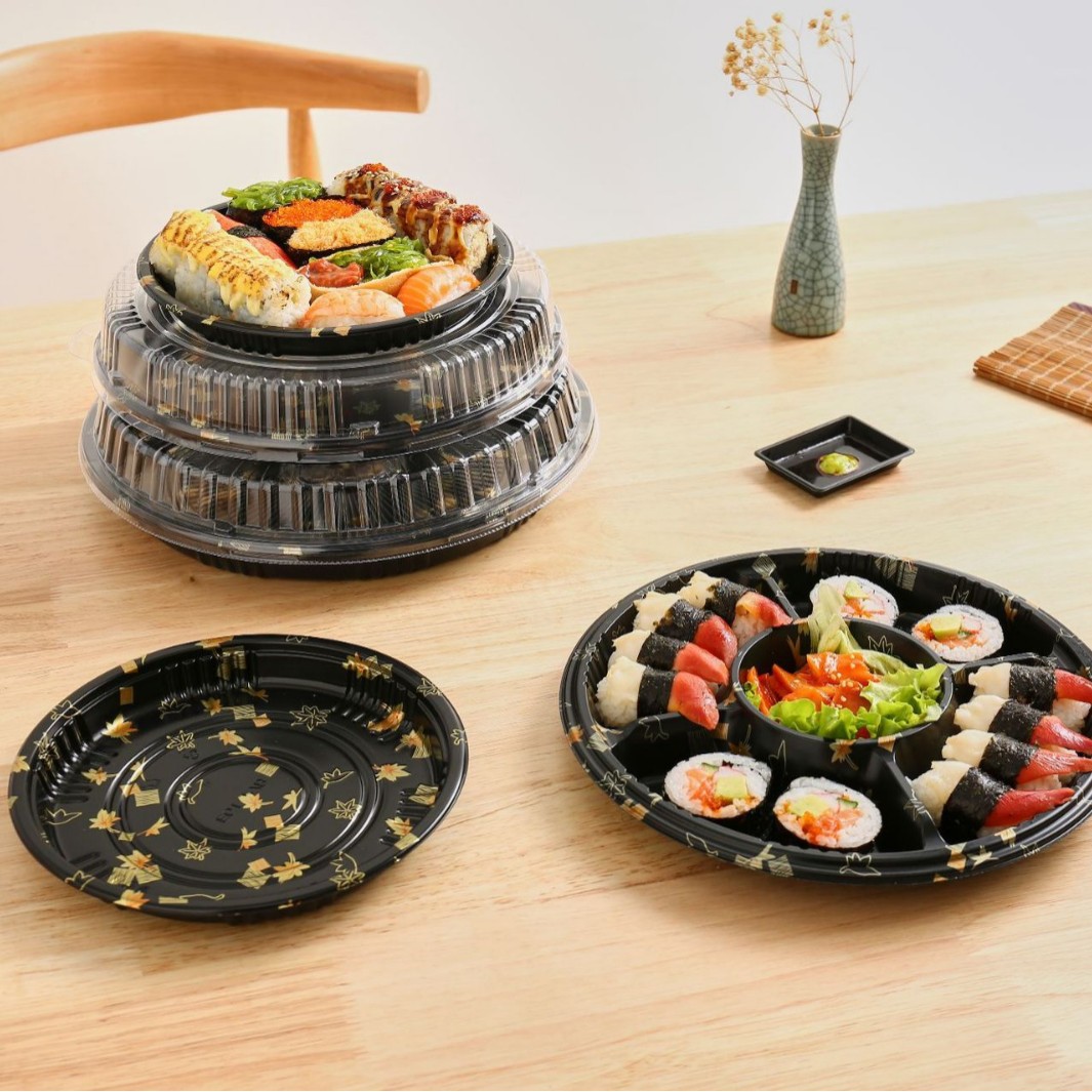 Black sushi tray filled with assorted sushi and prepared food for restaurant presentation