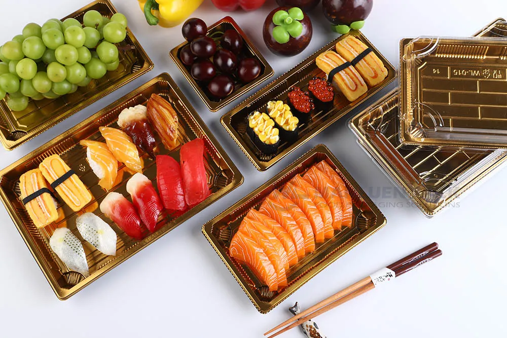 Assorted sushi containers with clear lids displaying sushi rolls, sashimi, and Japanese food items