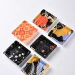 Assorted decorative WL-0.1 small square sushi trays in black, gold and red patterns