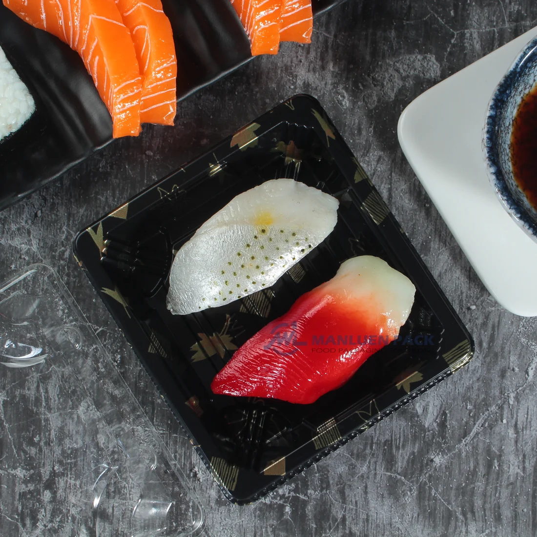 Close-up of sushi in a black WL-0.1 maple leaf tray with clear lid