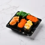 Assorted sushi served in a black WL-0.1 small square sushi tray
