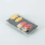 Black WL-0.6 sushi tray with clear fitted lid holding assorted sushi