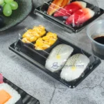 Compact black WL-00 sushi tray used in a styled food-service display