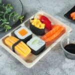 Close-up of assorted sushi displayed in a natural WL-03 bagasse rectangular tray