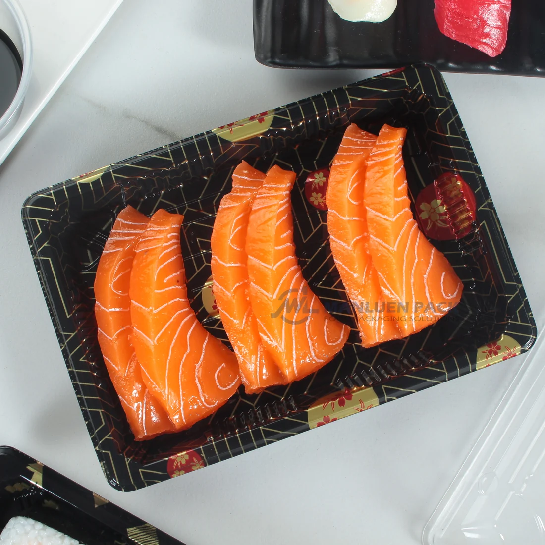 WL-03 Black Pattern Sushi Tray Salmon Display | Manluen Pack Black patterned WL-03 sushi tray displaying salmon sushi beside its clear fitted lid