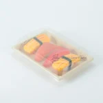 Assorted sushi packed in a natural WL-05 bagasse tray with clear lid