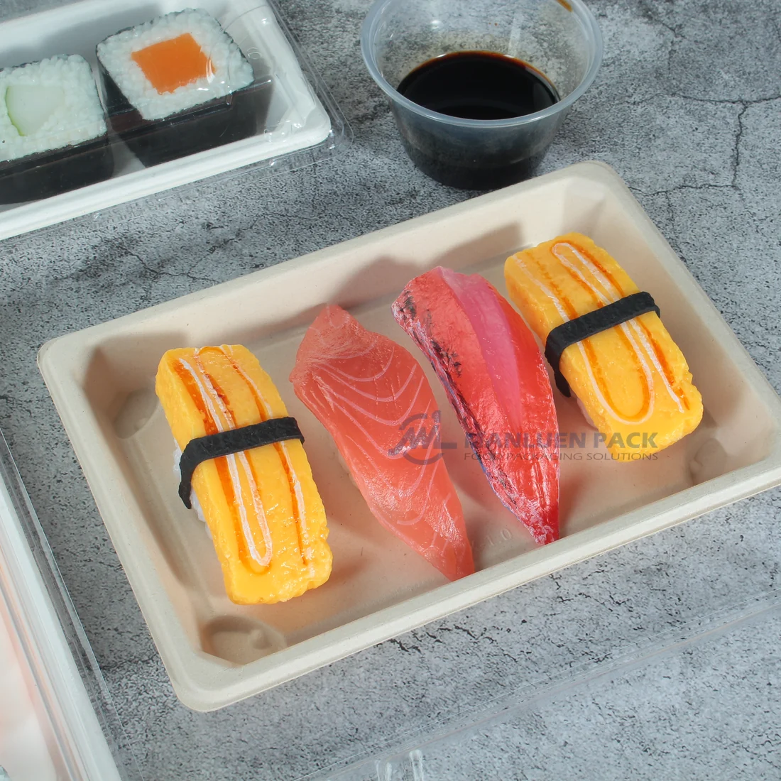 WL-05 Bagasse Sushi Tray Tabletop Close Up | Manluen Pack WL-05 bagasse sushi tray with natural kraft color surface for eco friendly food packaging
