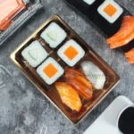 Top view of assorted sushi arranged in a WL-05 rectangular tray