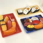 WL-05 sushi trays in several color finishes displaying assorted sushi