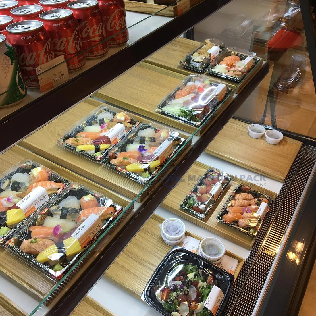 WL-07 sushi trays arranged with assorted takeaway foods at a restaurant counter