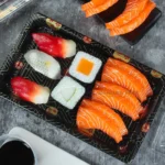 Open black WL-09 sushi tray displaying assorted sushi