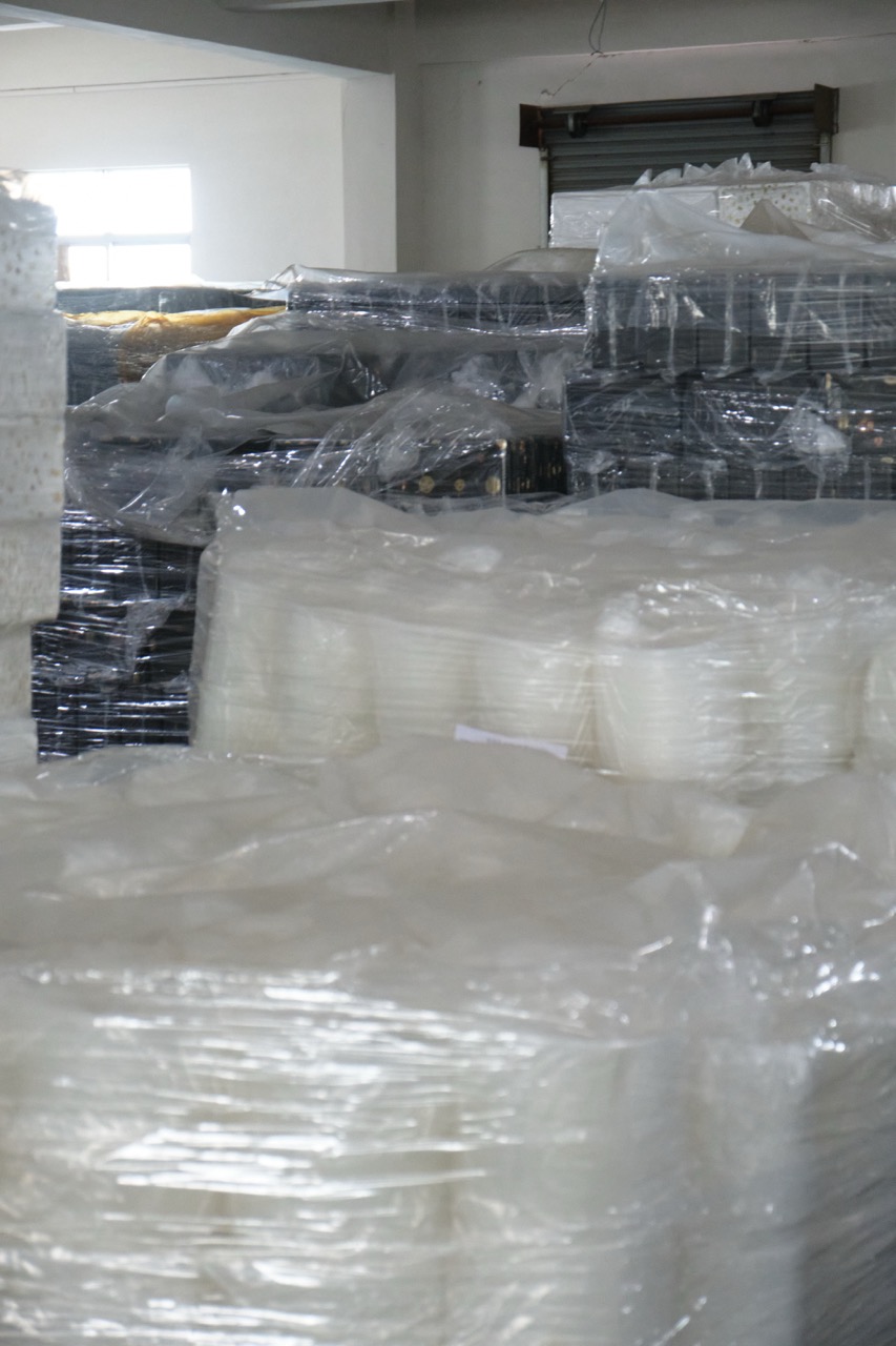 Secondary packaging of disposable food containers wrapped and stacked for storage and shipment at Manluen Pack