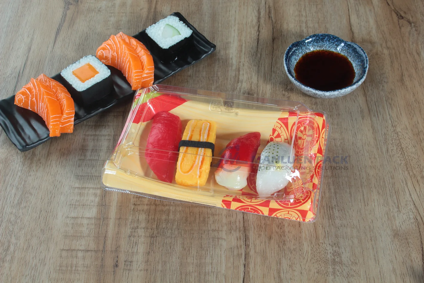 Covered WL-20B Lucky sushi tray with assorted nigiri on a wooden table