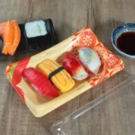 Open WL-20B Lucky sushi tray with assorted nigiri beside its clear lid