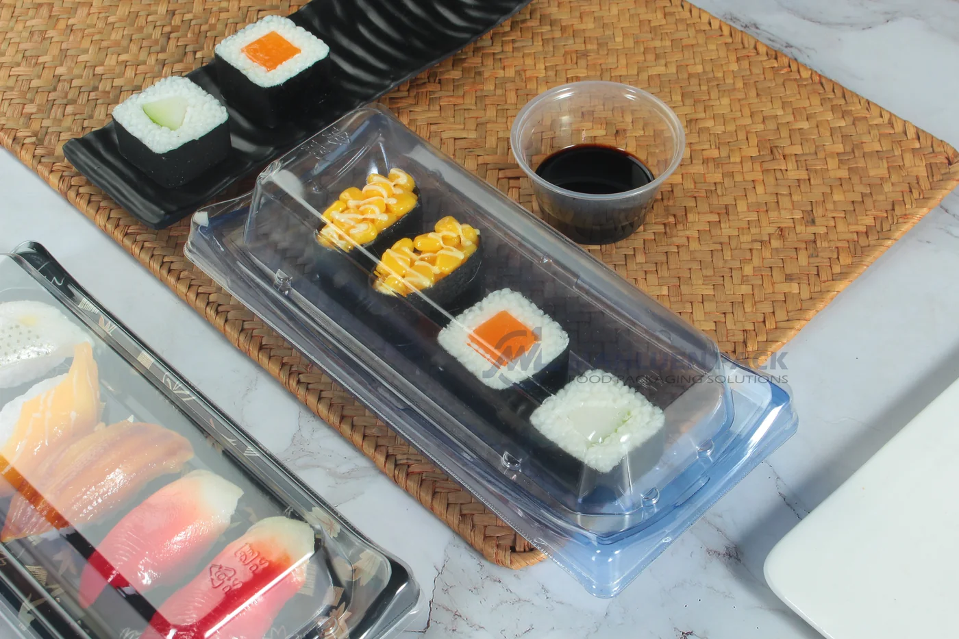 Covered WL-30B sushi tray with sushi rolls in a tabletop setting