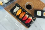 WL-B01 boat shape sushi tray shown in a open sushi tray tabletop view