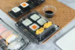 WL-B03 boat shape sushi tray shown in a covered sushi tray tabletop view