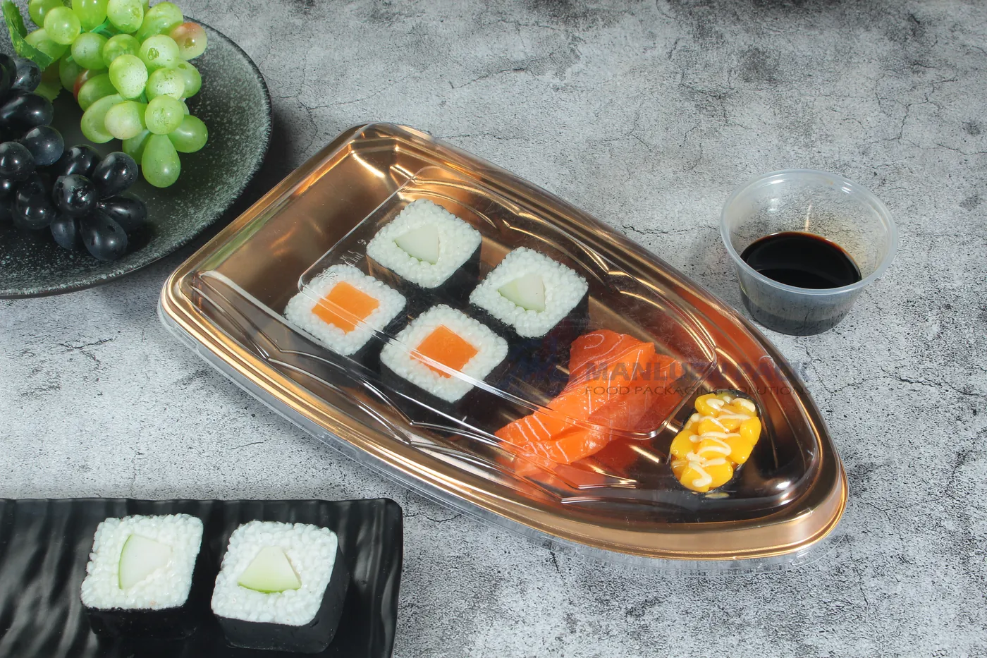 WL-B16 boat shape sushi tray shown in a gold boat sushi tray lifestyle view