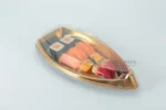 WL-B16 boat shape sushi tray shown in a gold covered boat tray studio