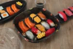 WL-C019 sushi packaging shown in a open square sushi tray tabletop view