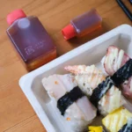 WL-05 bagasse sushi tray shown in a wide tabletop view