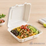 Bagasse clamshell container with a burrito bowl, avocado and fresh vegetables