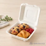 Bagasse clamshell food container holding pastries, muffins and fresh berries