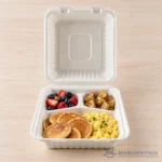 Three-compartment bagasse container with pancakes, fruit and breakfast sides