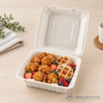 BG91 bagasse hinged clamshell food container filled with chicken and waffles in product view