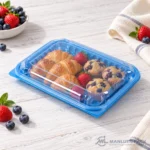 WL-CM011 closed plastic hinged clamshell food container filled with croissants, muffins and berries in angled view