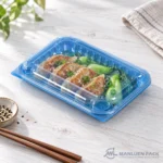WL-CM011 closed plastic hinged clamshell food container filled with dumplings bok choy in angled view