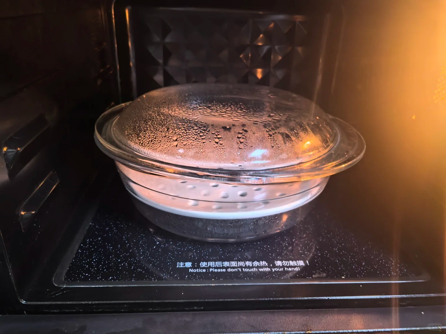Covered glass food container heating inside a microwave