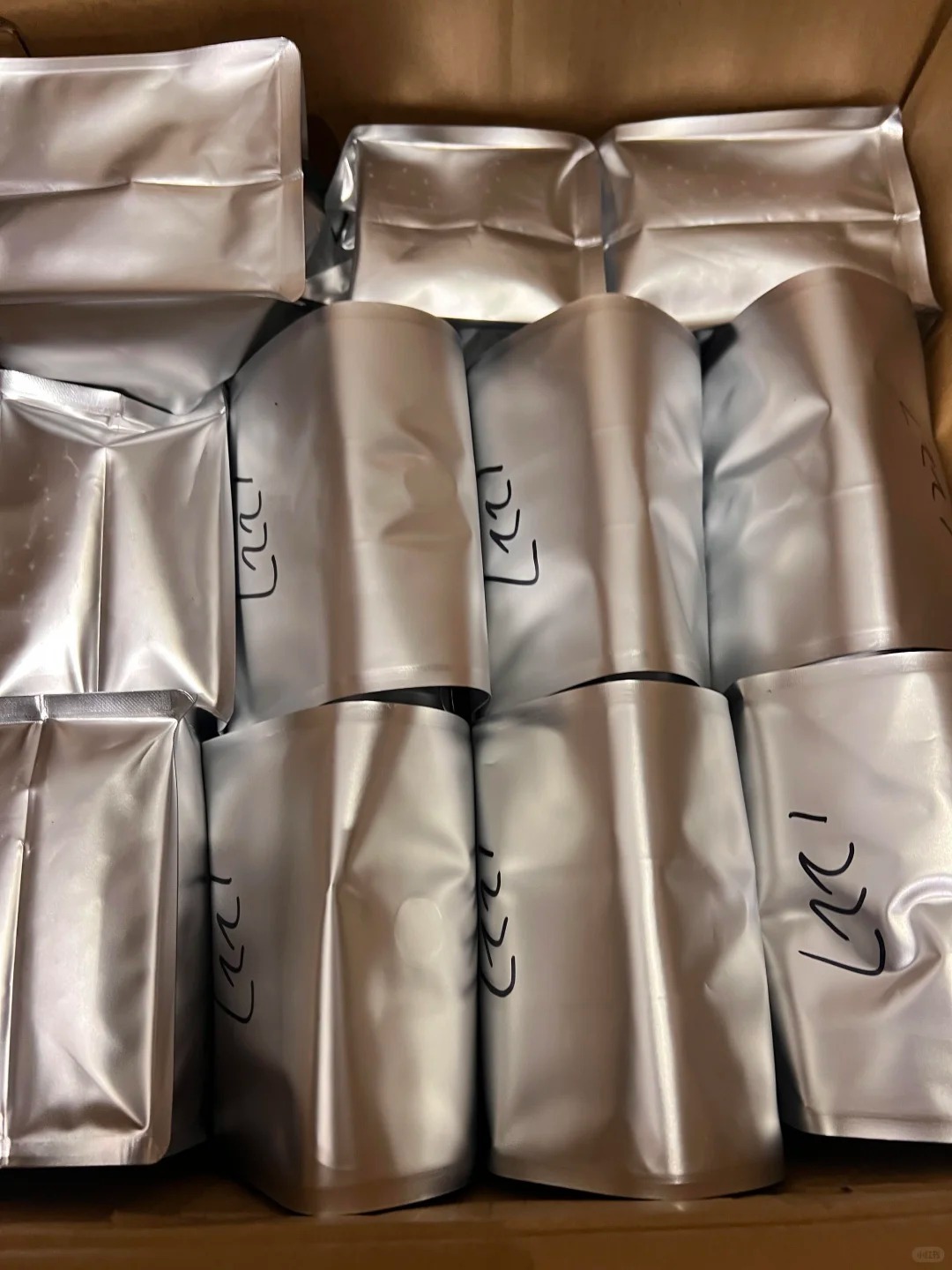 Is Aluminum Foil Safe for Food Packaging? A 2026 Buyer’s Guide 3 Silver aluminum foil food packaging pouches packed in a carton for storage and transport.